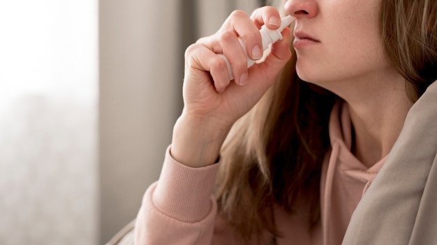 close up woman taking treatment runny nose 23 21485060291